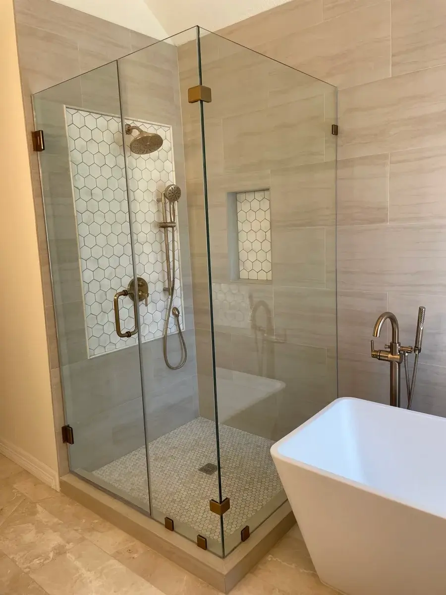 Frameless shower enclosure